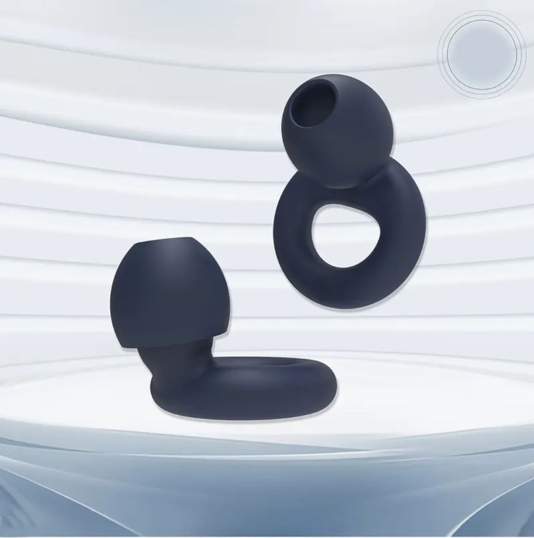 Two dark blue silicone ring-shaped hello calm sound filtering earplugs on a light gray background